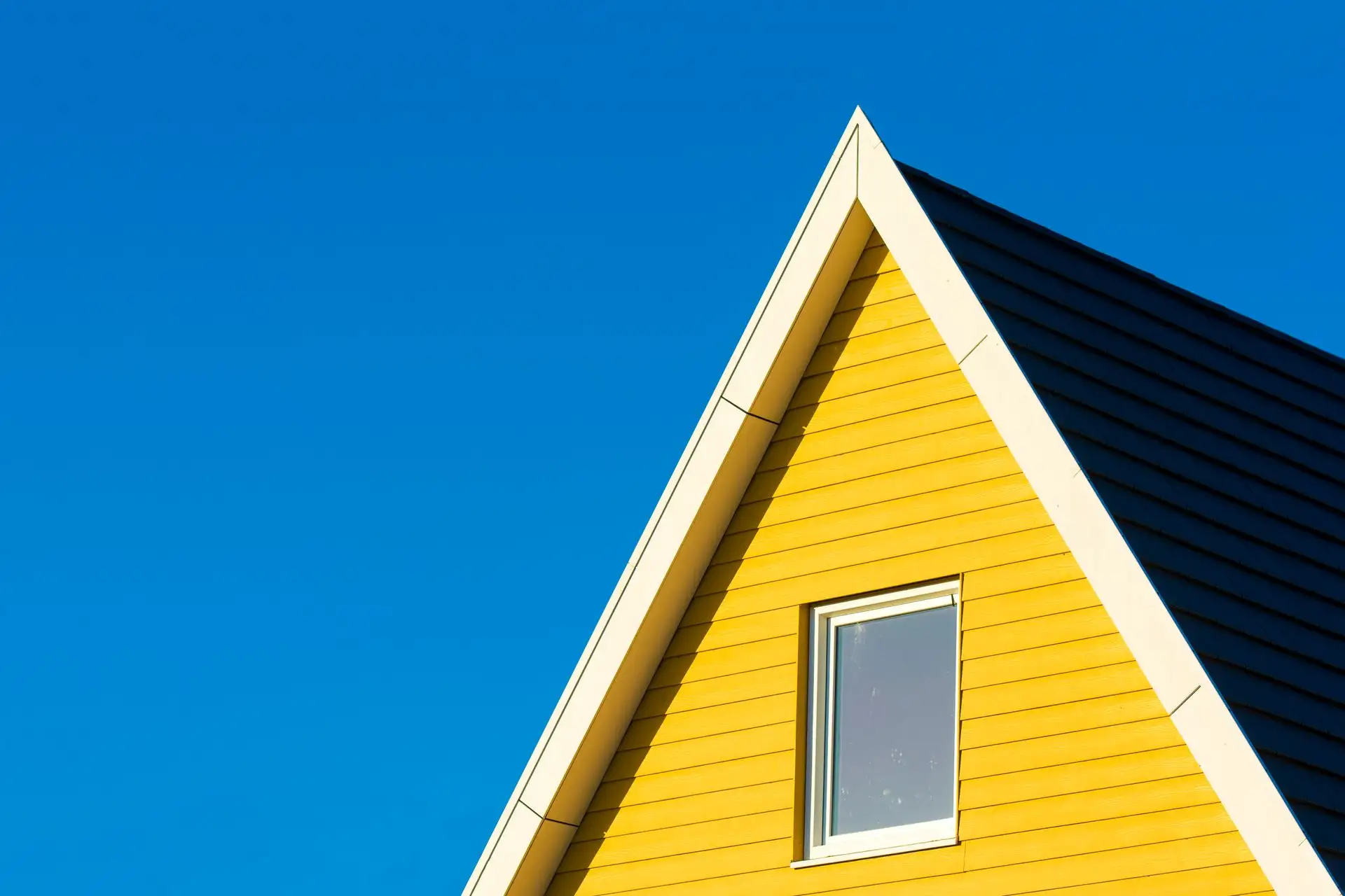 Gable end and eave detail cutting across a pale sky