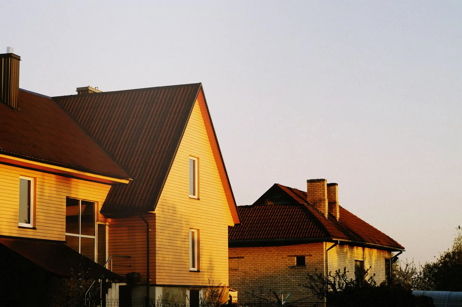 Steep residential roofs catching golden-hour light