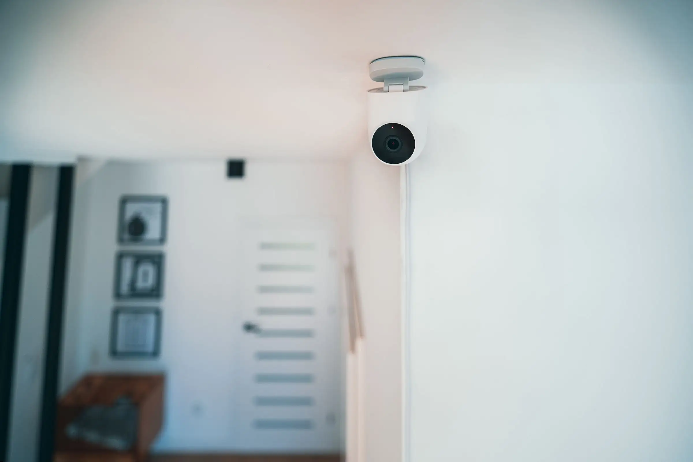 Small indoor security camera mounted in a contemporary room