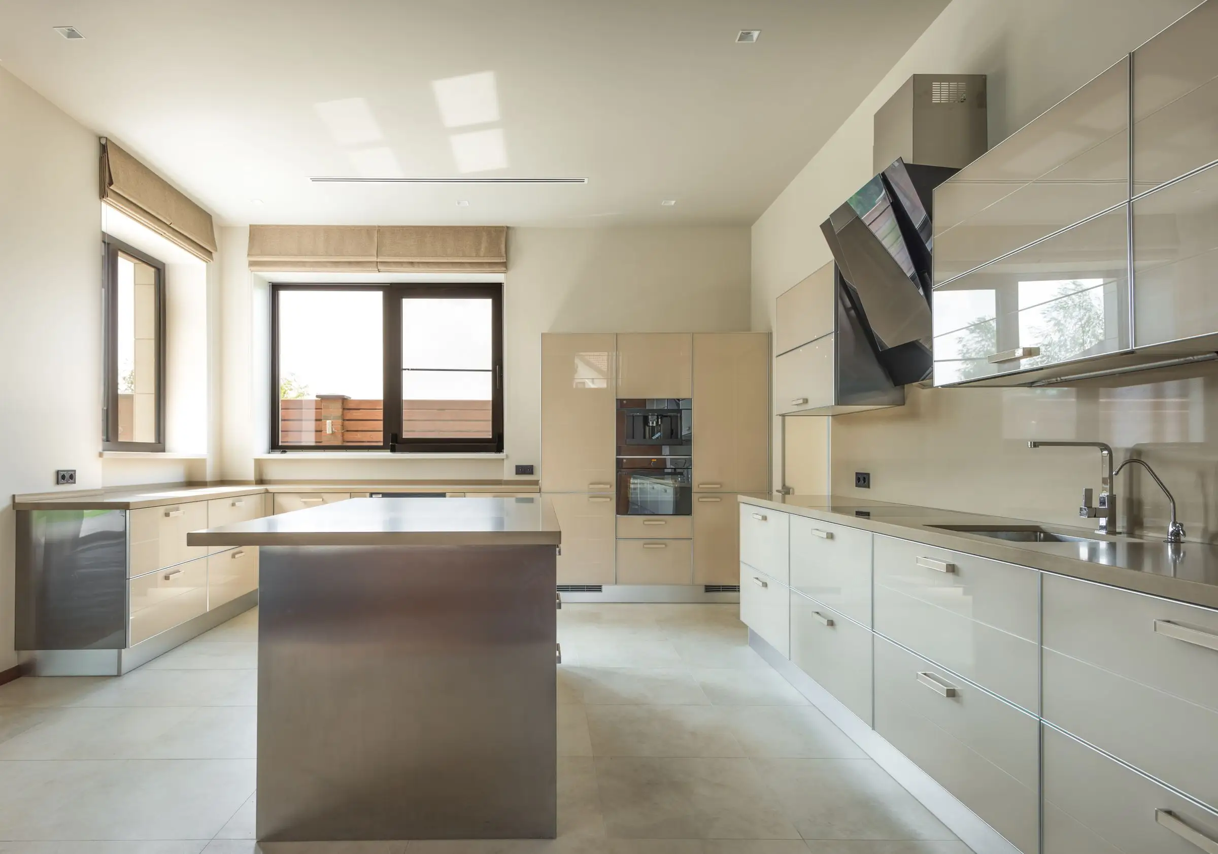 Fitted kitchen with a central island and plain cabinet fronts