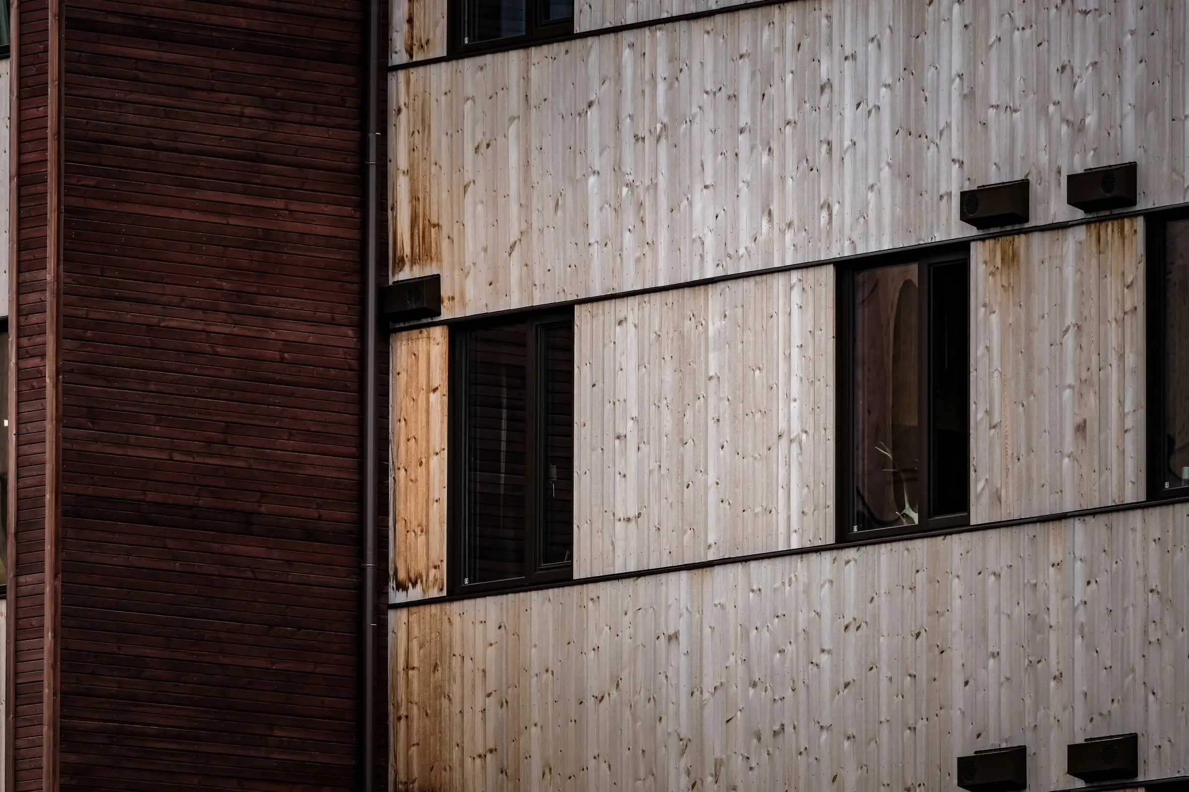 Modern facade alternating wood panels and window openings