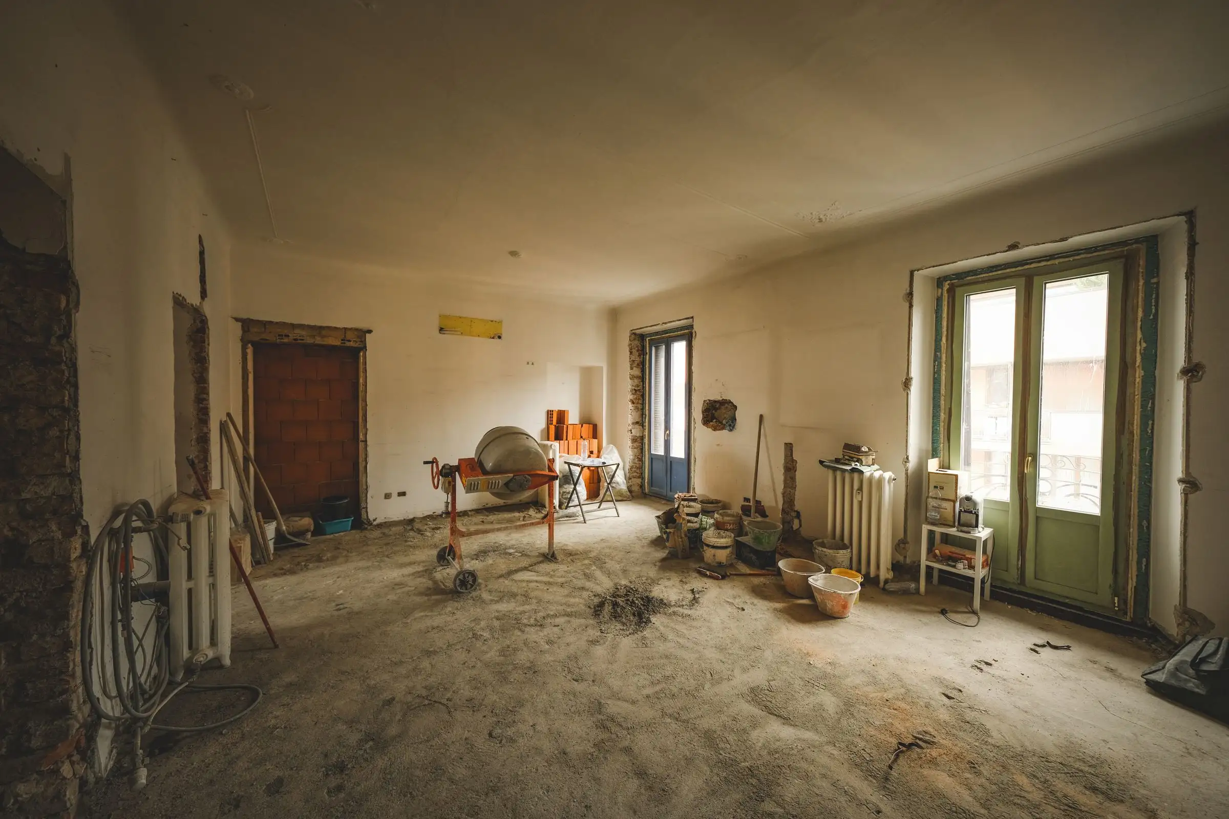Room stripped back mid-renovation with tools and materials on the floor