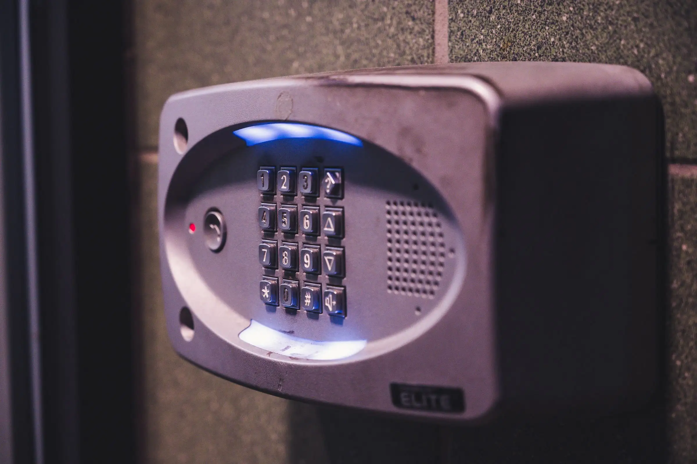 Illuminated alarm keypad mounted on an interior wall